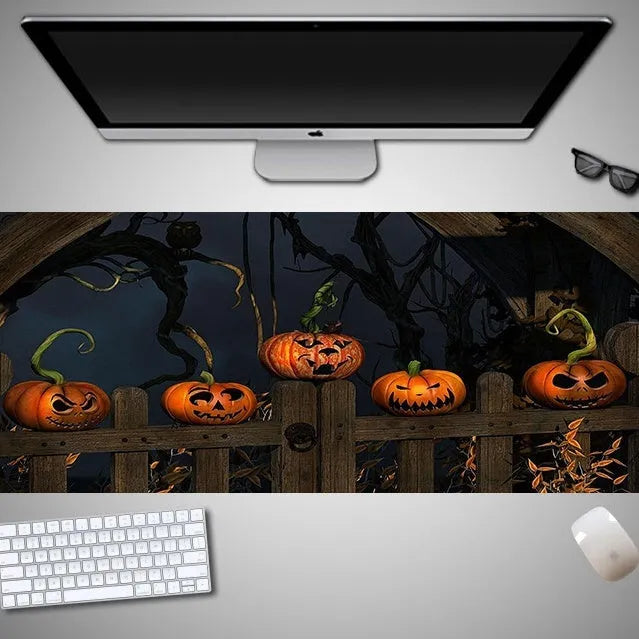 Oversized Halloween-themed mouse pad with non-slip rubber base on a desk.