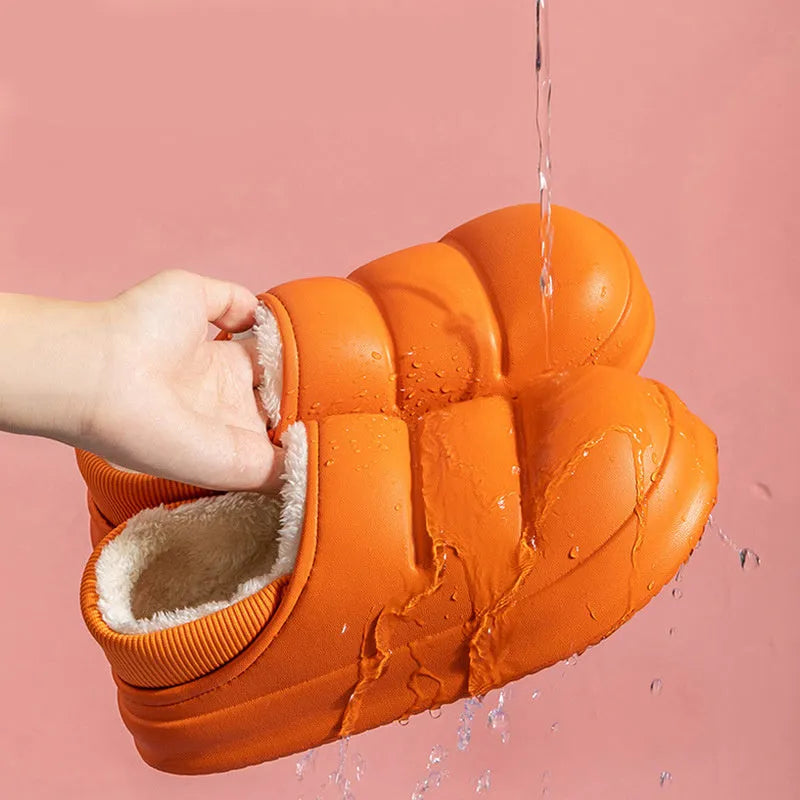 A pair of waterproof EVA couple slippers in green with a plush lining and non-slip sole.