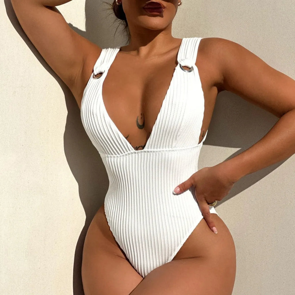Women's solid colour one-piece swimsuit on a hanger in black, white, green, and orange.