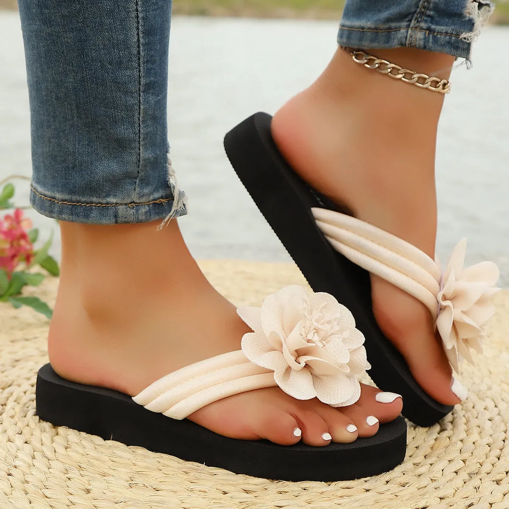 Solid-colour floral flip-flops with a lightweight EVA sole on a plain background.
