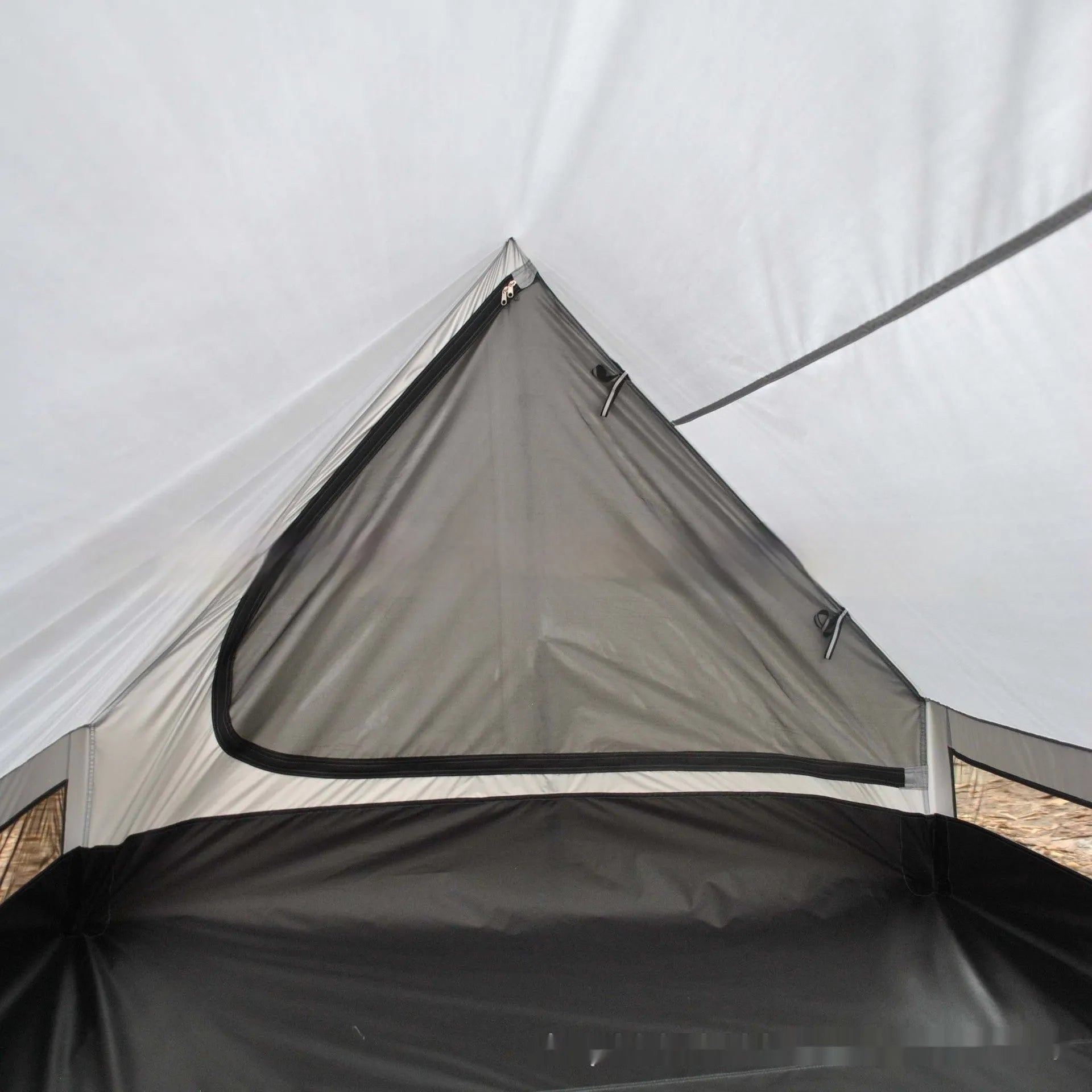 Brown A-line hiking tent erected with hiking poles showing spacious interior for 2-3 people