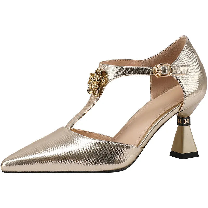 Women's gold genuine leather sandals with hollowed design and pointed toe on a white background.