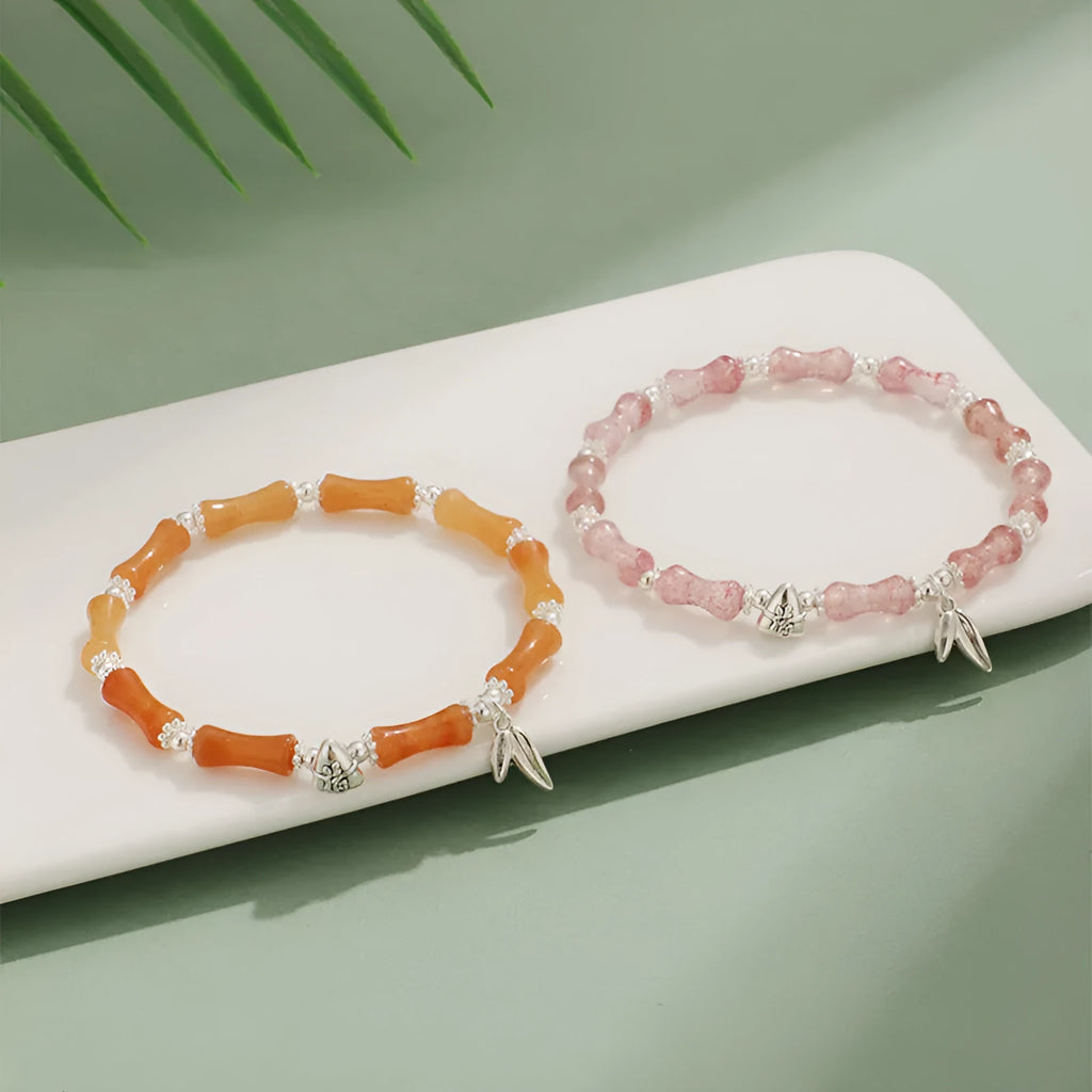 Green aventurine bamboo bead crystal bracelet with strawberry quartz and Dongling stones on wrist.