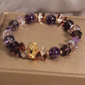 Purple crystal bracelet with pumpkin beads and rhinestone detailing on adjustable band