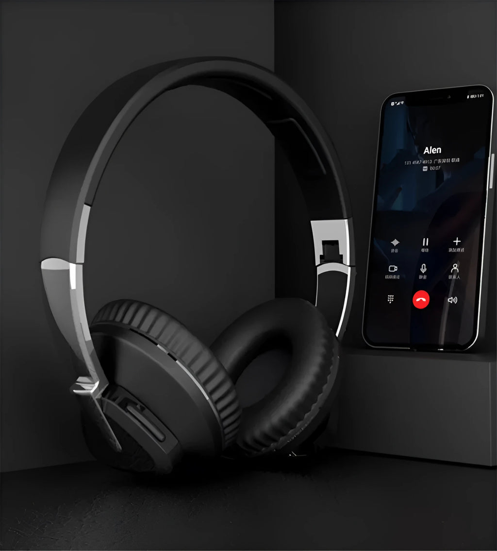 Wireless Bluetooth over-ear headphones in black colour with all-inclusive ear design showing AUX port and control buttons