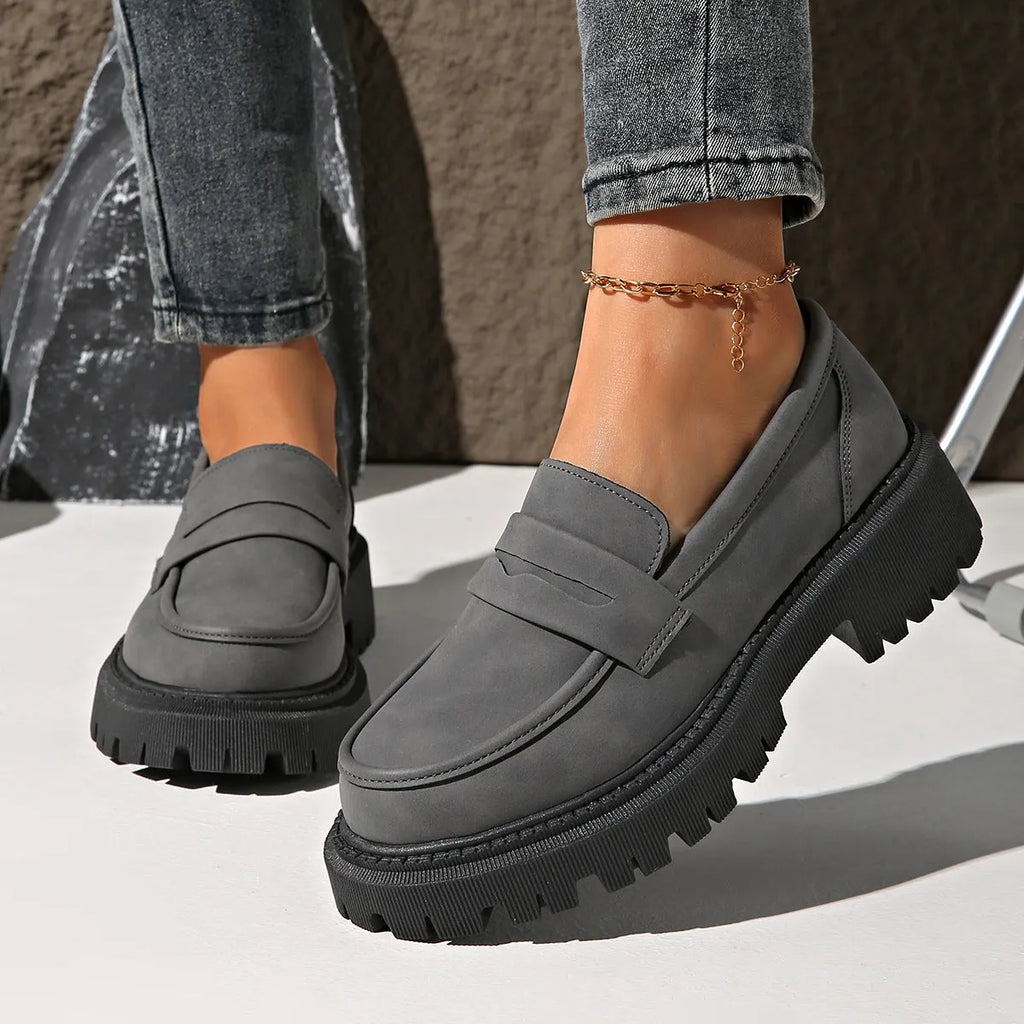 Gray British style slip-on low cut loafers with low heel and rubber sole