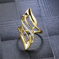 Women's copper ring with exaggerated curved design and gold-coloured finish showing side profile