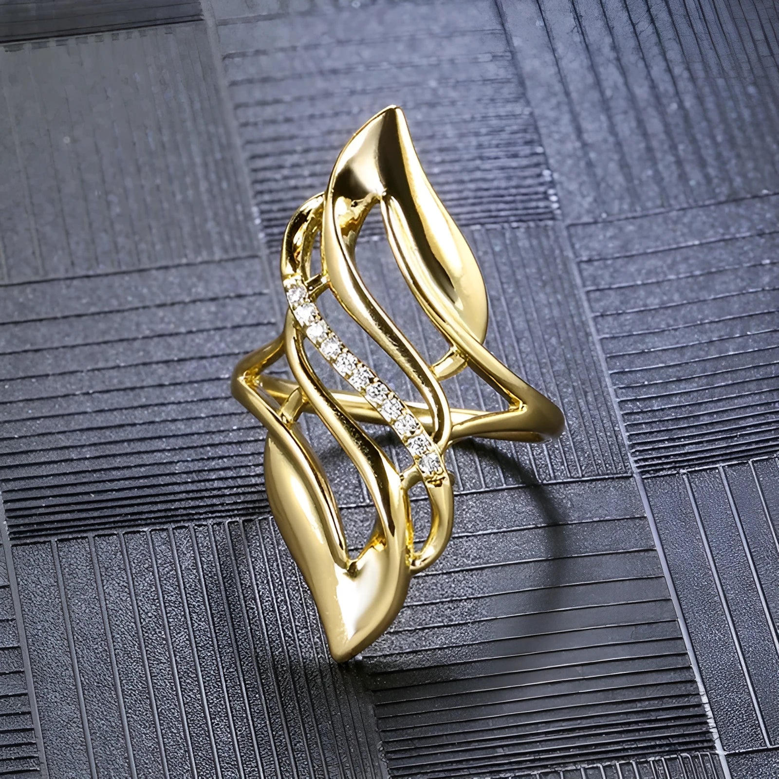 Women's copper ring with exaggerated curved design and gold-coloured finish showing side profile