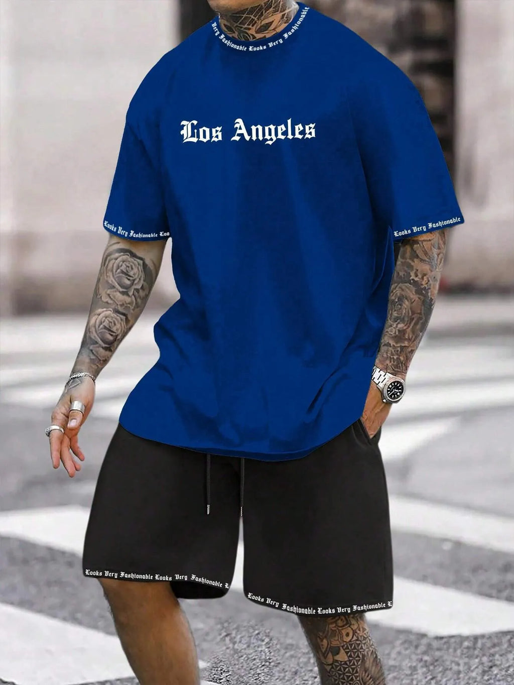 Man wearing a blue printed short-sleeve top and matching shorts from a quick-dry sports set.