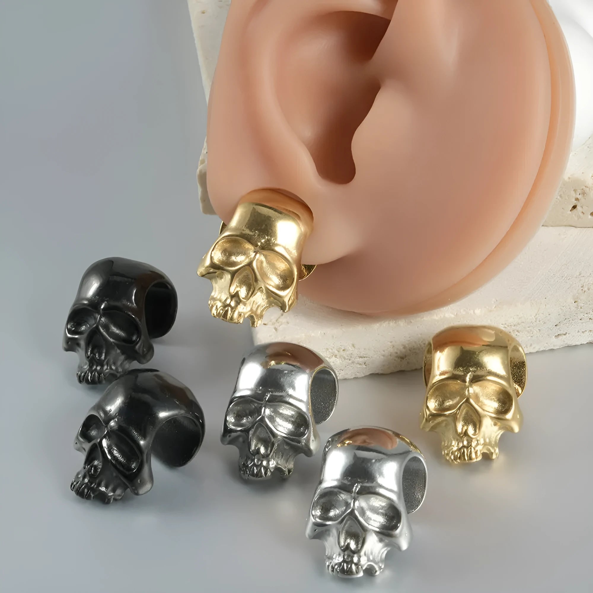 Stainless steel geometric earrings with hollow skull and Buddha head design in gold, black, steel, or Buddha head finish.
