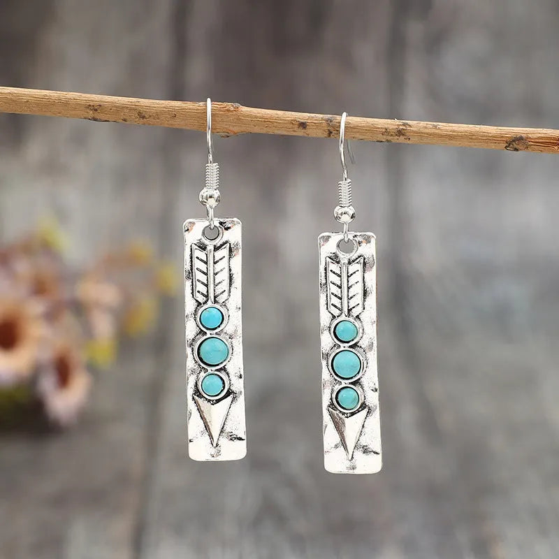 Long geometric silver earrings with turquoise inlay detail, retro style women's jewellery