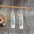 Long geometric silver earrings with turquoise inlay detail, retro style women's jewellery