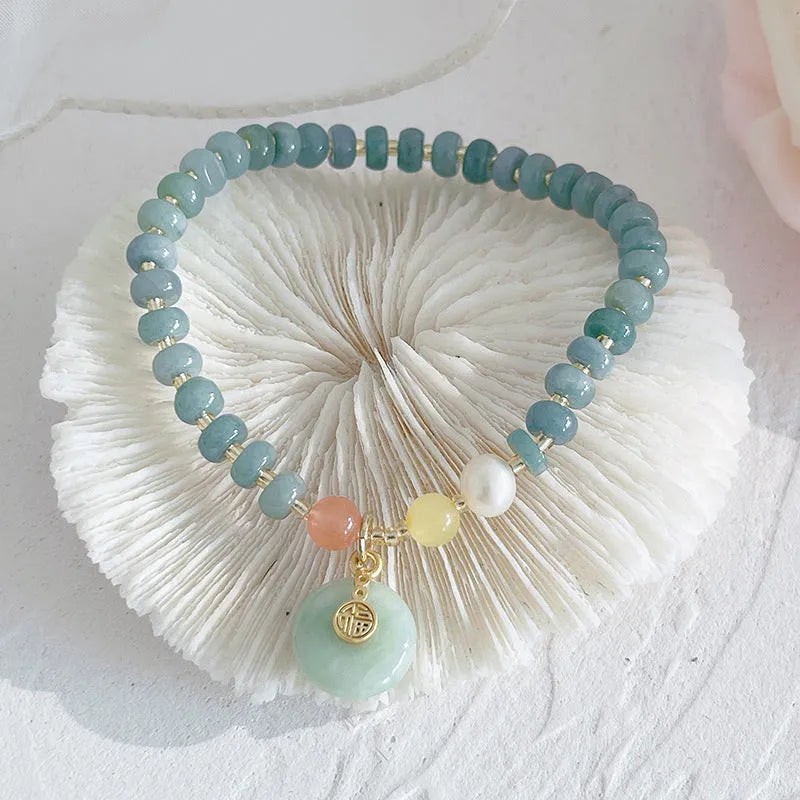 Natural blue water jade bracelet with gourd beads and peace buckle charm on woman's wrist