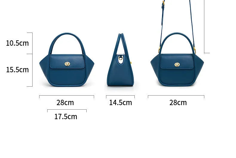 Women's wing-shaped leather tote bag with a latch buckle, shown in Atlantic blue with a cross-body strap.