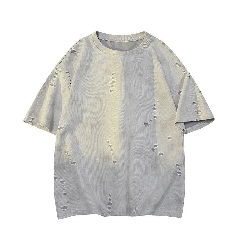 Men's blue loose-fit distressed short-sleeve t-shirt with ripped fabric detailing on a casual backdrop.