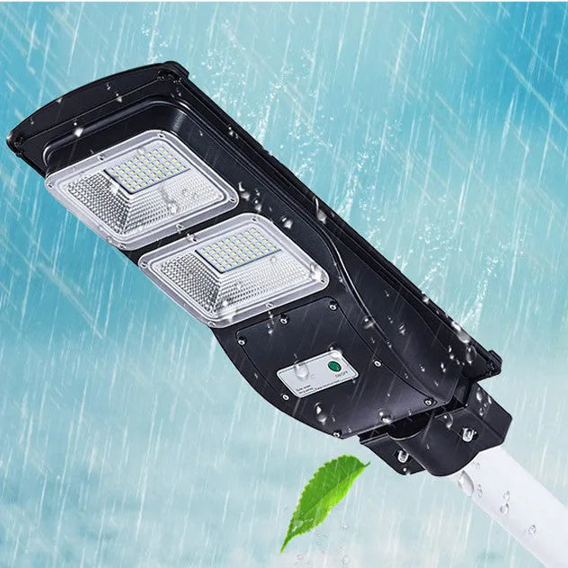 Integrated solar street light with solar panel on top and LED light unit below, for outdoor installation.