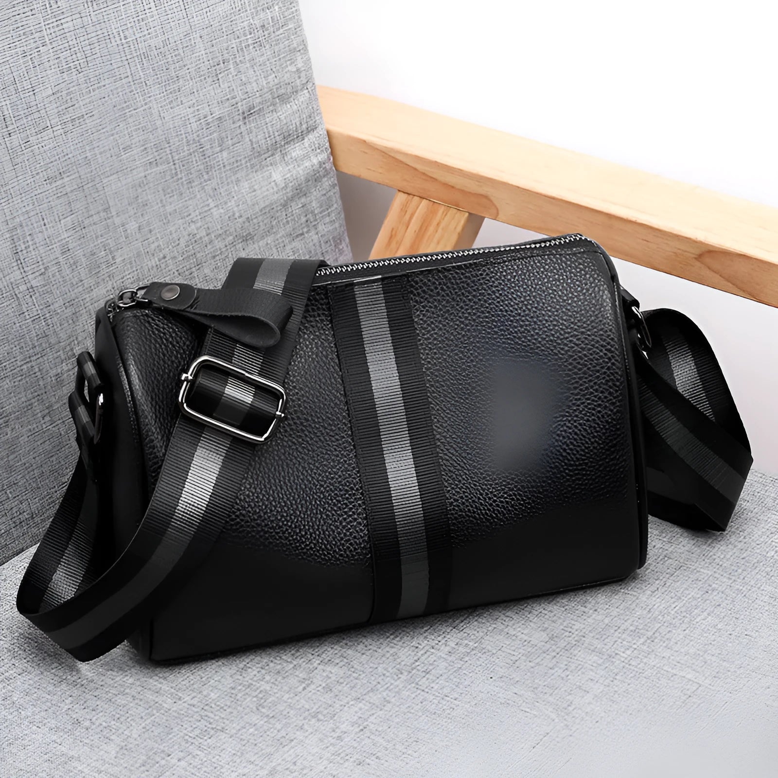 Black genuine leather crossbody shoulder bag showing front view and dimensions