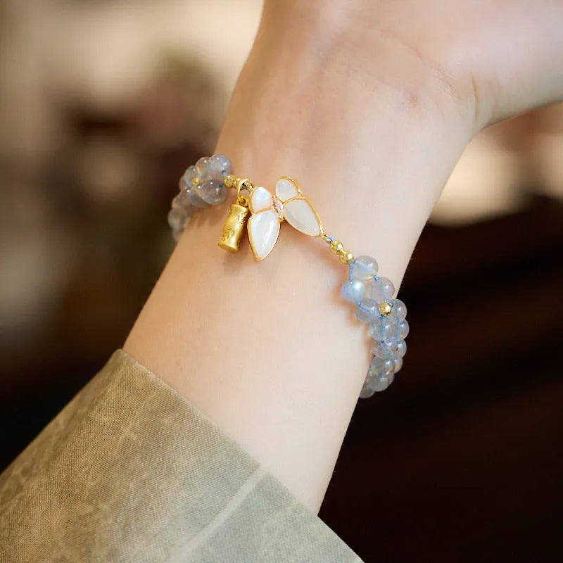 Handmade geometric woven bracelet for women with a grey moonstone and butterfly design.