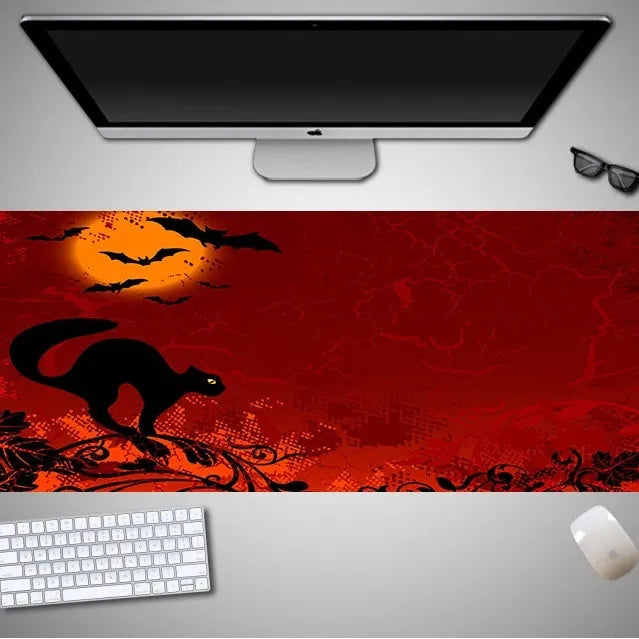 Oversized Halloween-themed mouse pad with non-slip rubber base on a desk.