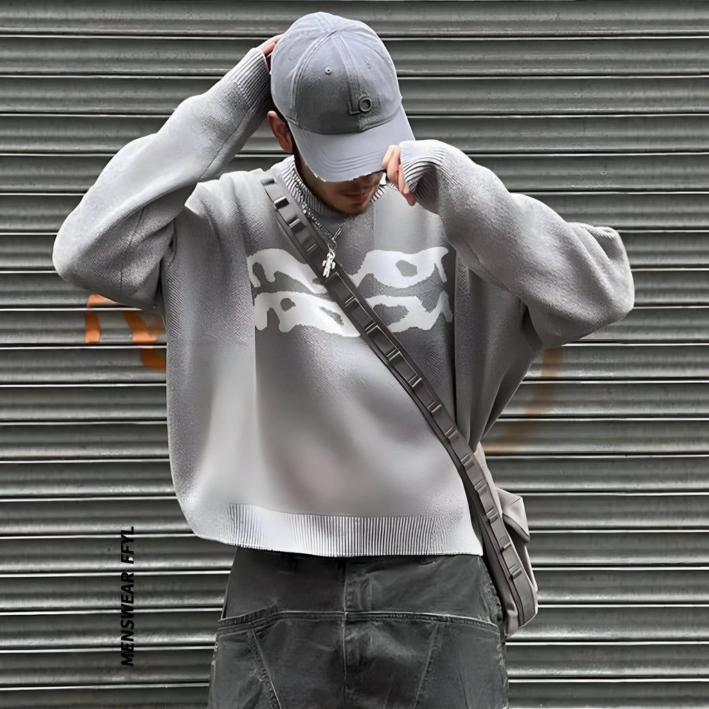 Loose geometric jacquard pullover knitted sweater in gray, front view, showing textured pattern and relaxed fit