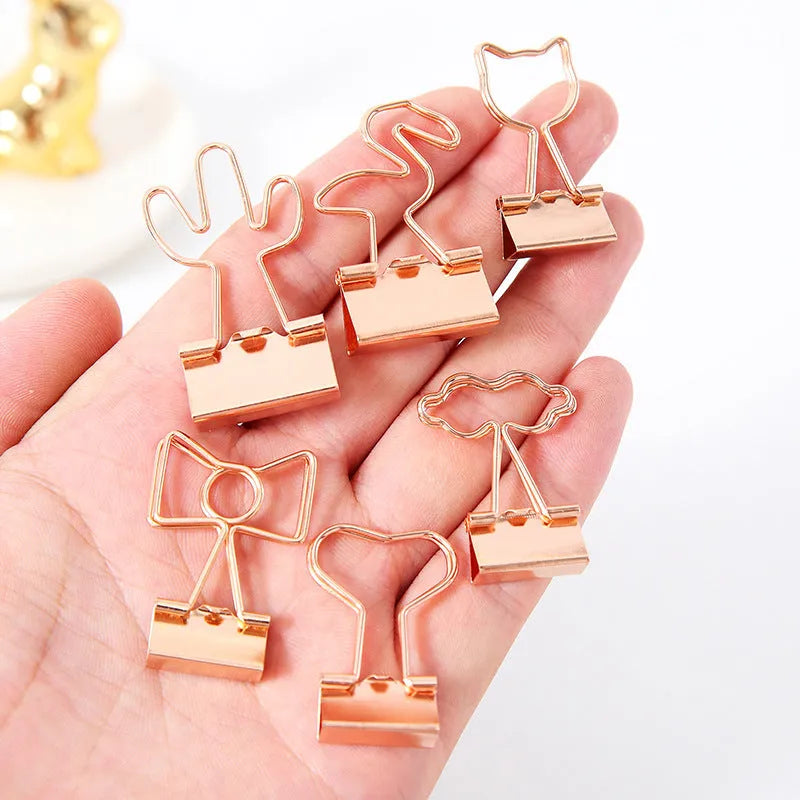 Gold-coloured metal alligator hair clip in a choice of flamingo, love, cloud, cat, cactus, or bow shapes.
