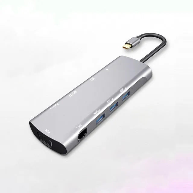 Grey aluminium USB-C docking station with HDMI, VGA, USB 3.0, and USB-C PD charging ports.