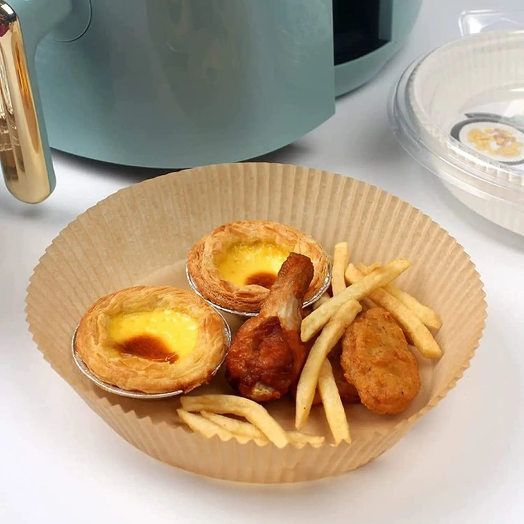 Round white disposable parchment paper liner for air fryer basket with raised edges.