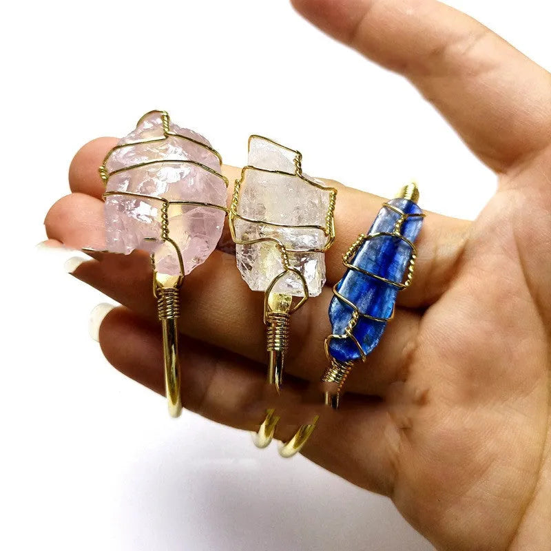 Unisex geometric bracelet with rough natural crystals and gold winding metal on a wrist.
