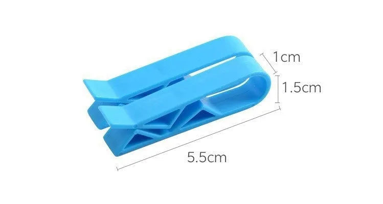 Green and black non-slip plastic clip for holding a bin bag on a wheelie bin rim.