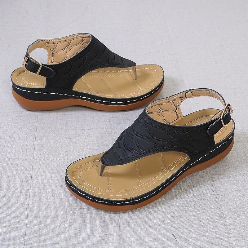 Women's casual wedge heel flip flop sandals with an adjustable buckle strap in a solid colour.
