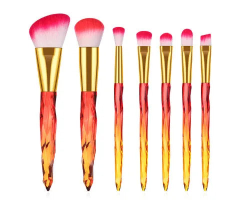 Ten crystal-handle foundation brushes with artificial fibre bristles in black, blue, red, and yellow colours.