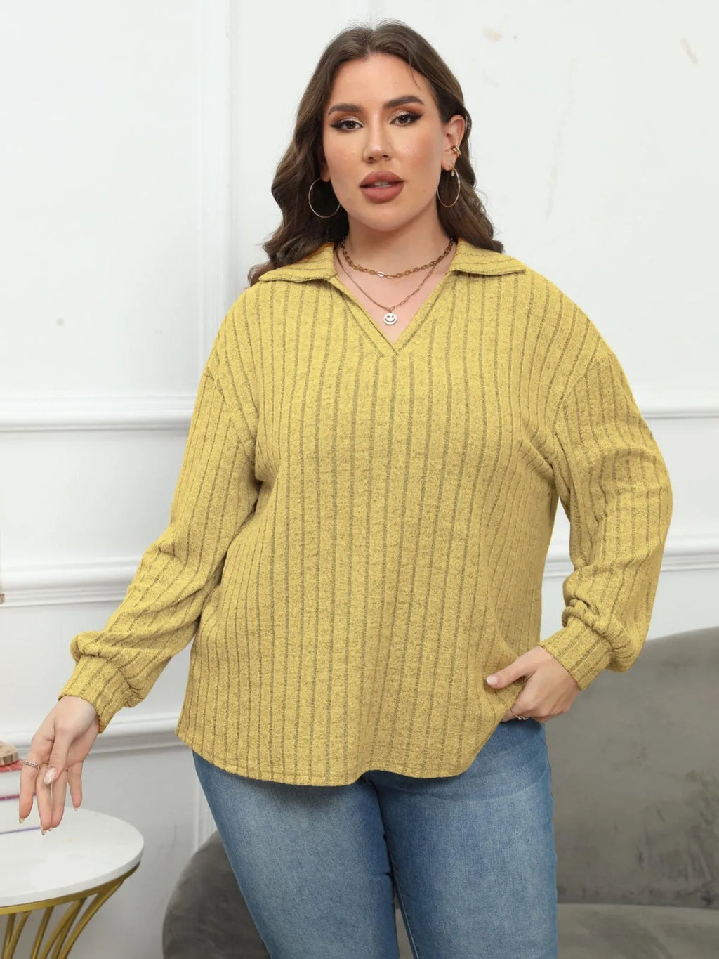 Women's plus size grey polo collar fleece shirt with lantern sleeves on a hanger.