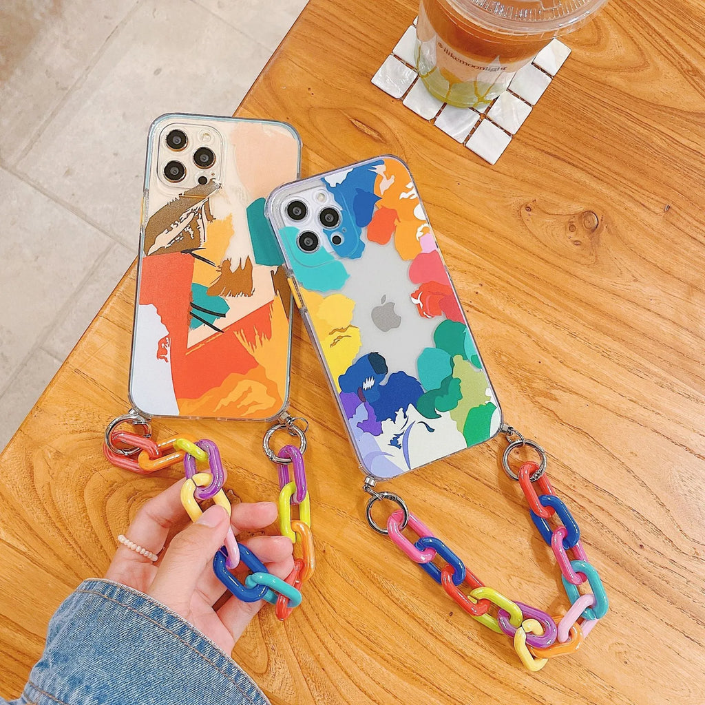Clear TPU mobile phone case with printed graffiti design and integrated wrist strap attachment for iPhone