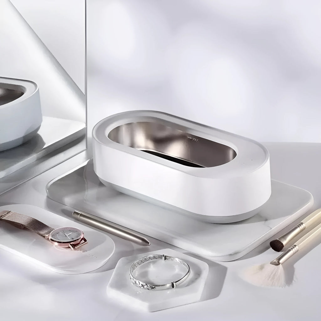 White portable ultrasonic cleaner with stainless steel tank and touch button.