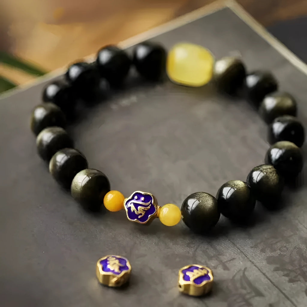 Handmade golden obsidian bracelet with 10mm geometric beads on a wrist, showing ethnic zodiac design.