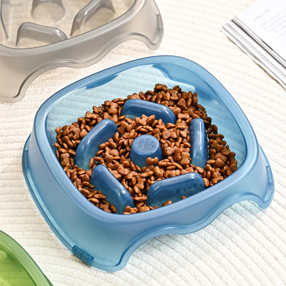 Blue plastic slow feeder dog bowl with raised internal maze pattern to prevent fast eating.