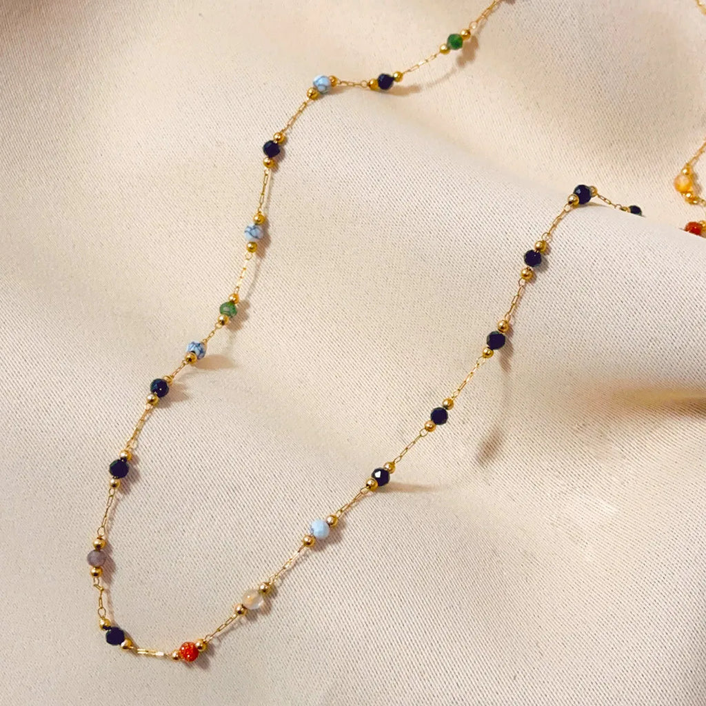 Gold titanium steel necklace with a natural stone pendant on an O-ring chain.