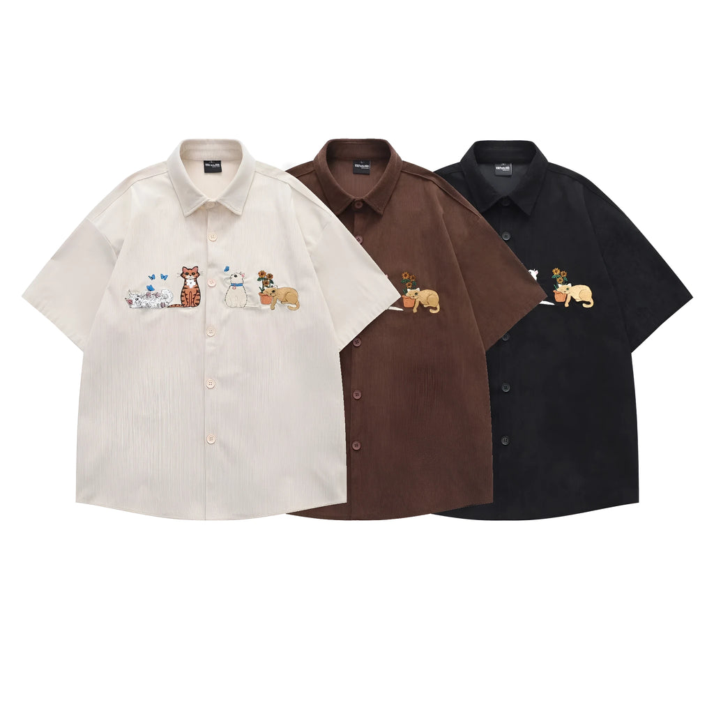 Loose apricot cardigan shirt with cartoon embroidery pattern on a hanger.