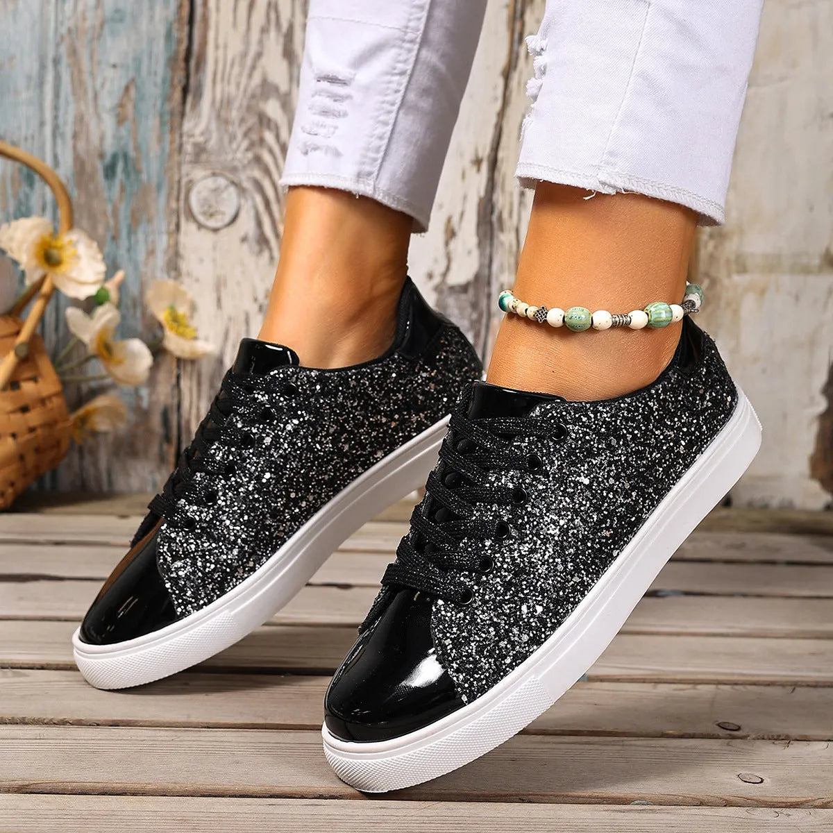 Women's plus size black sequined flat board shoes with front lace-up detail.