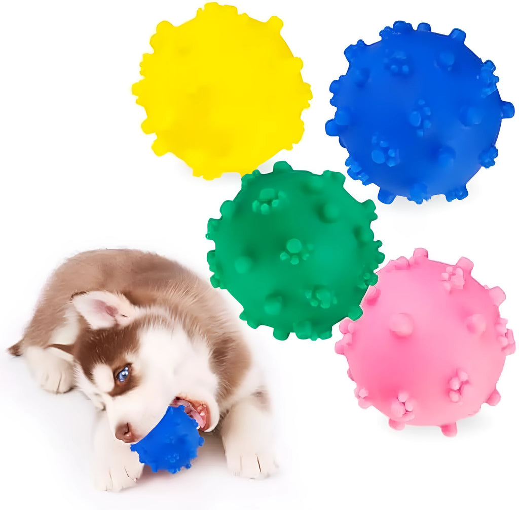 Blue, green, pink, and yellow spiky dog toy balls with paw print dimples, shown next to a small dog.