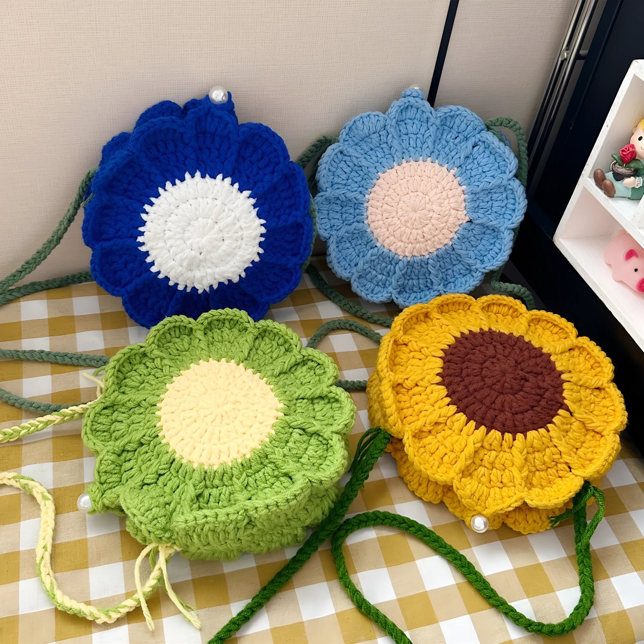 Round hand-woven wool crochet bag with floral detailing and cotton lining in colour options