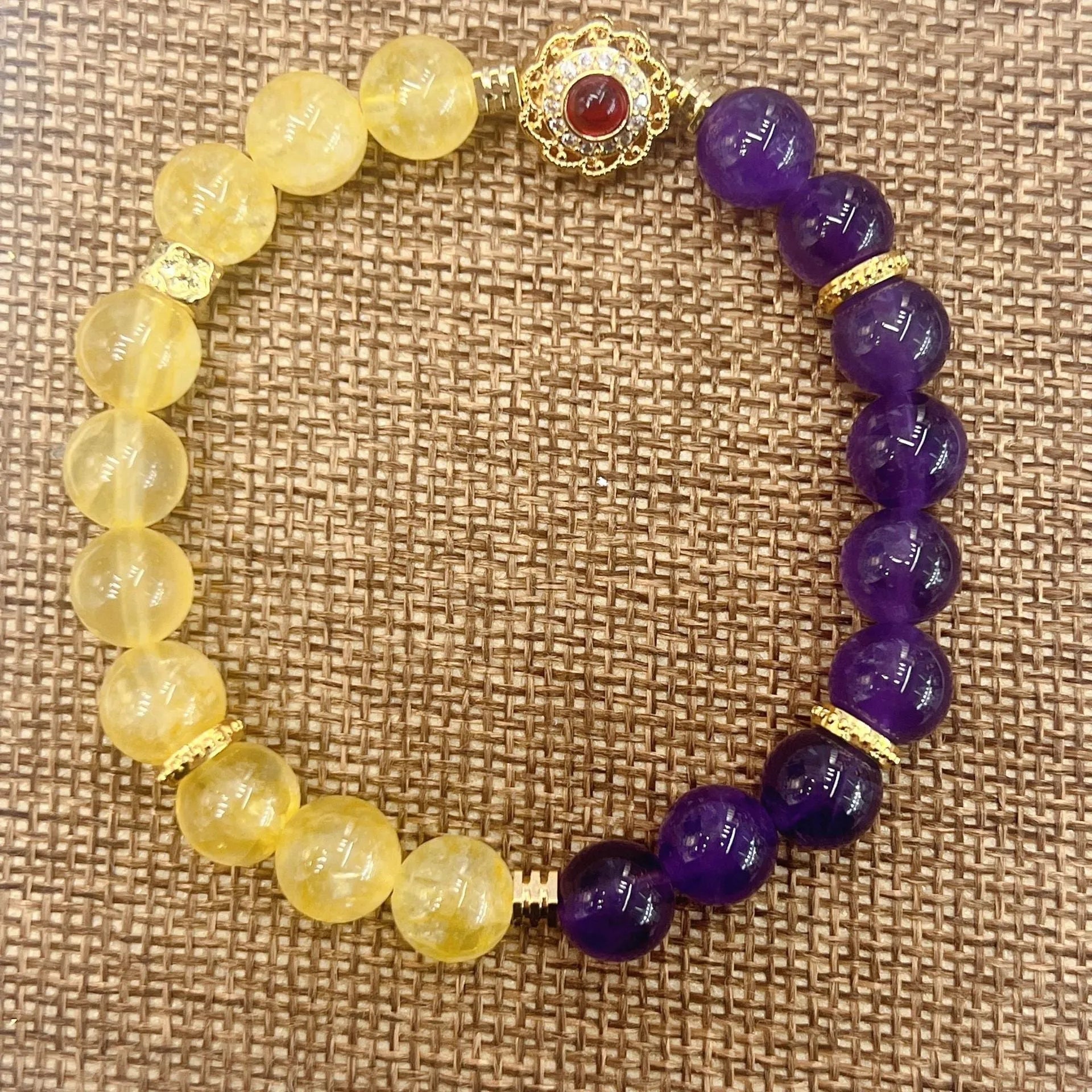 Handmade women's yellow and purple bracelet with amethyst and crystal beads featuring adjustable sliding knot closure