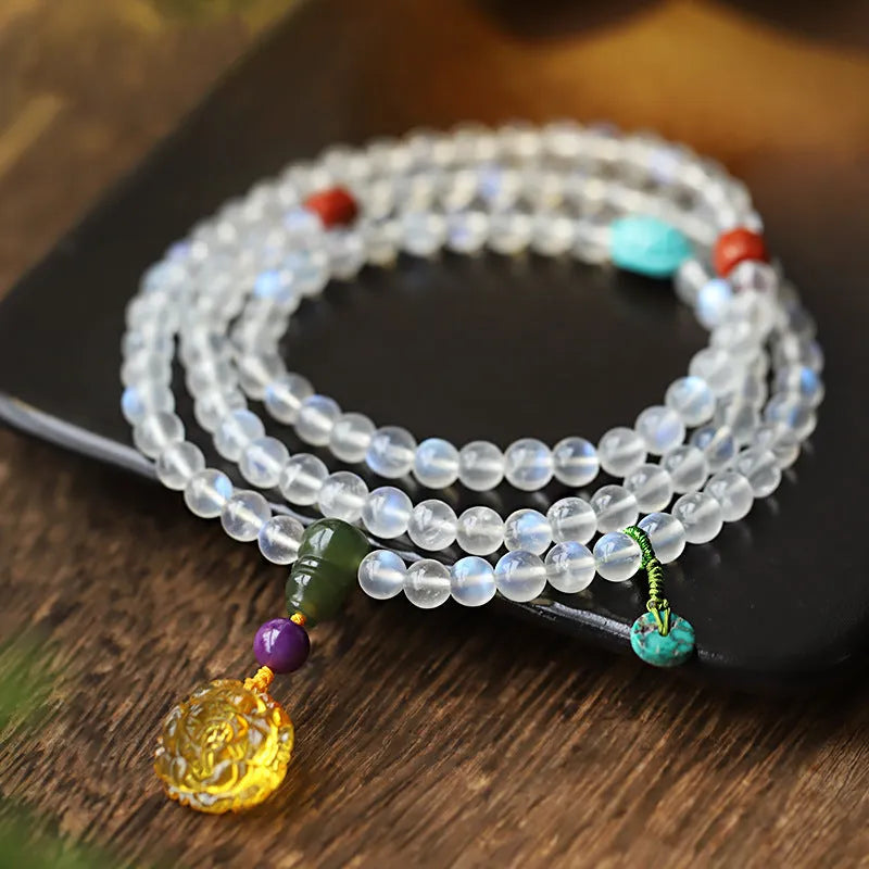 Blue light glass moonstone 108 prayer beads bracelet for women with beeswax finish white colour ethnic style.