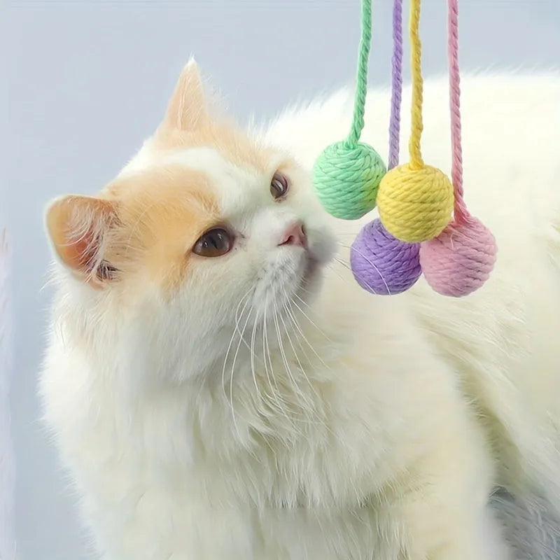 Colourful cat toy ball with rope attached and internal bell for kitten play stimulation