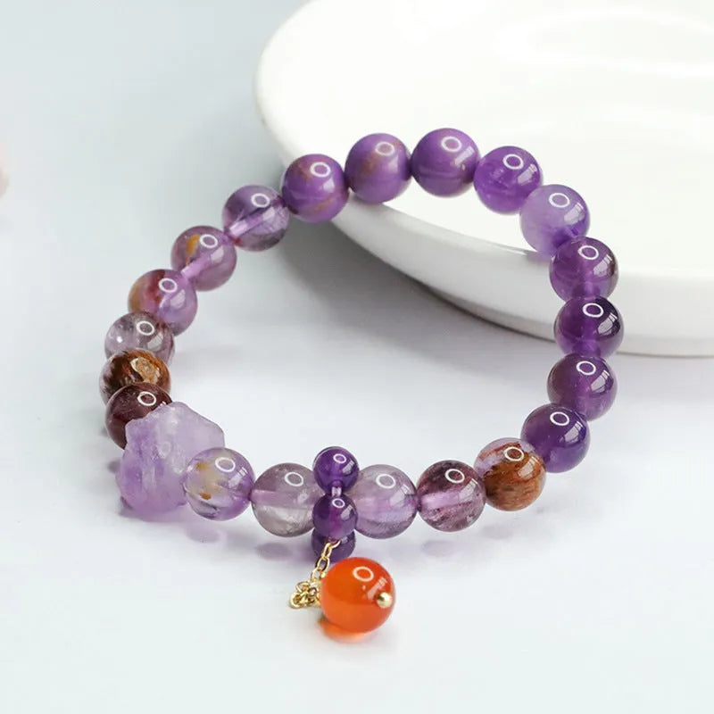 Nine purple fire amethyst and red agate Mori style bracelet with 8mm beads on adjustable cord.