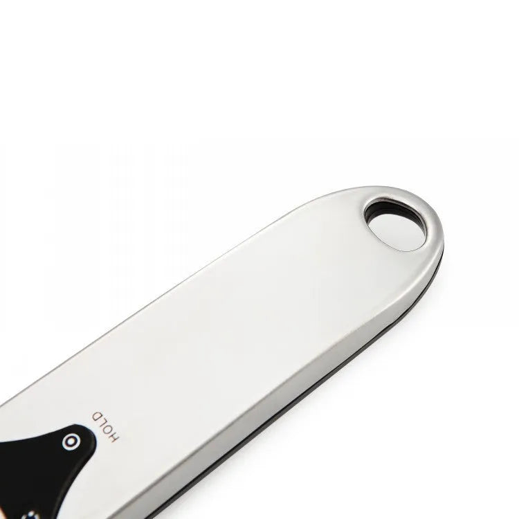 Smart digital measuring spoon with LCD display showing weight, used as a kitchen scale for food ingredients.