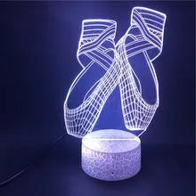 3D ballet dancer silhouette LED night light with remote control on a bedside table