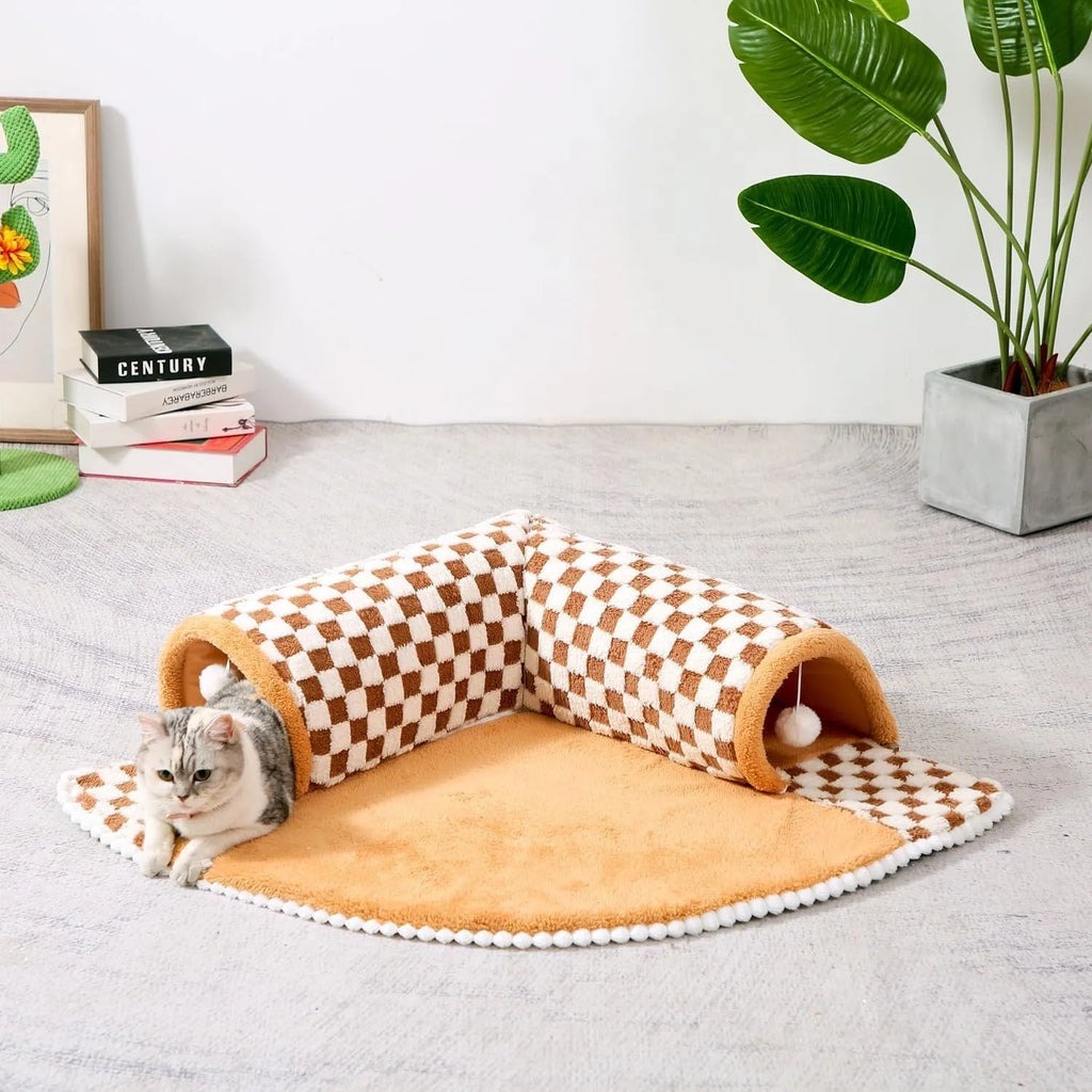 Coffee coloured plush 2-in-1 pet bed with a sleeping mat and an attached tunnel, showing anti-slip base.