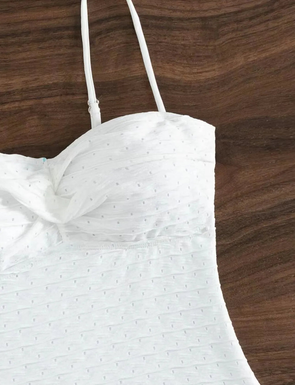White women's one-piece swimsuit with a sling back design on a mannequin.