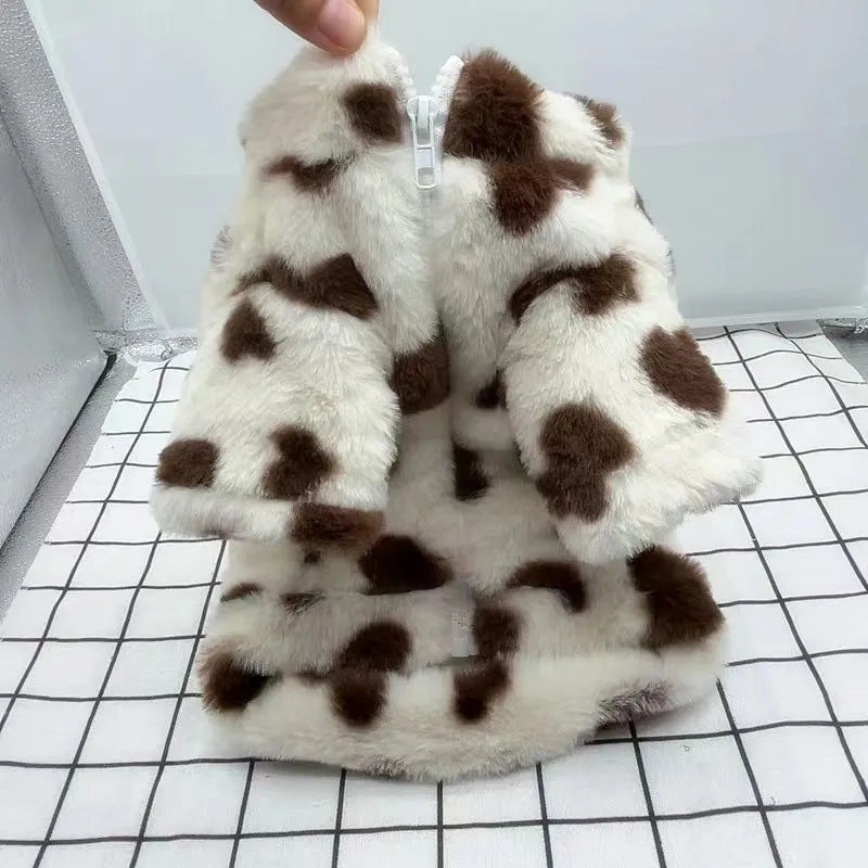 Small dog wearing plush warm coat in pink colour for cold weather protection